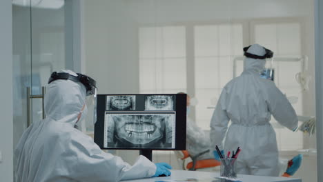 medical dentistry staff with ppe suits using modern technology