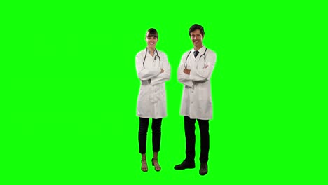 Front-view-of-doctors-smiling-at-camera-with-green-screen