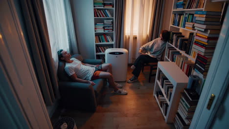 relaxing room with bookshelves and people