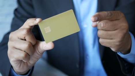 person holding a gold credit card