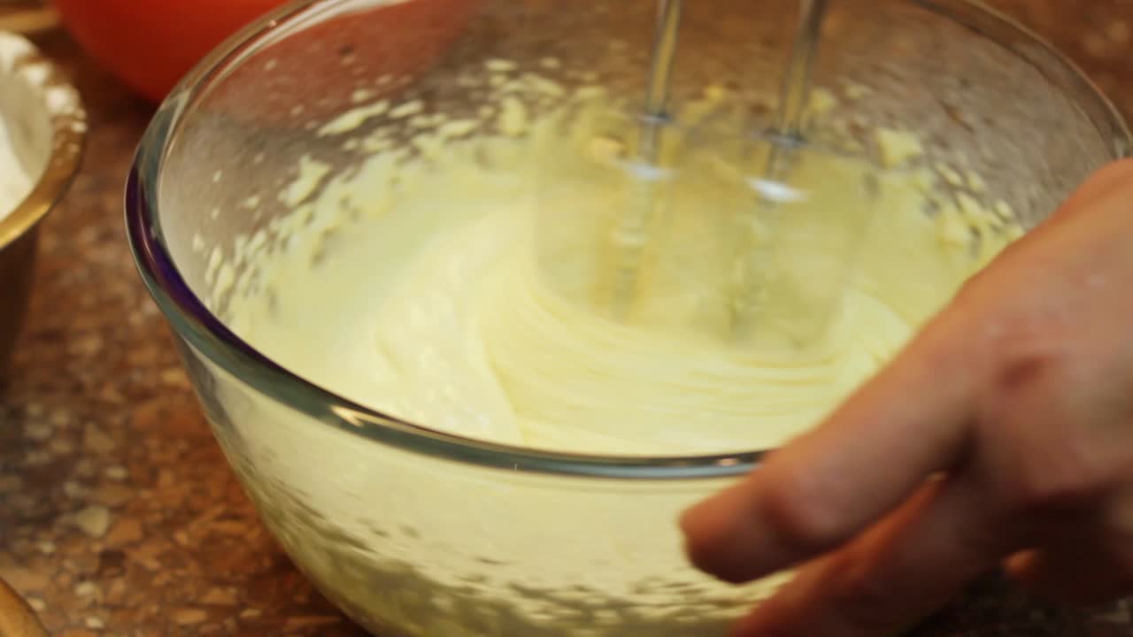 combinando yema de huevo de azúcar con batidora manual para pastel