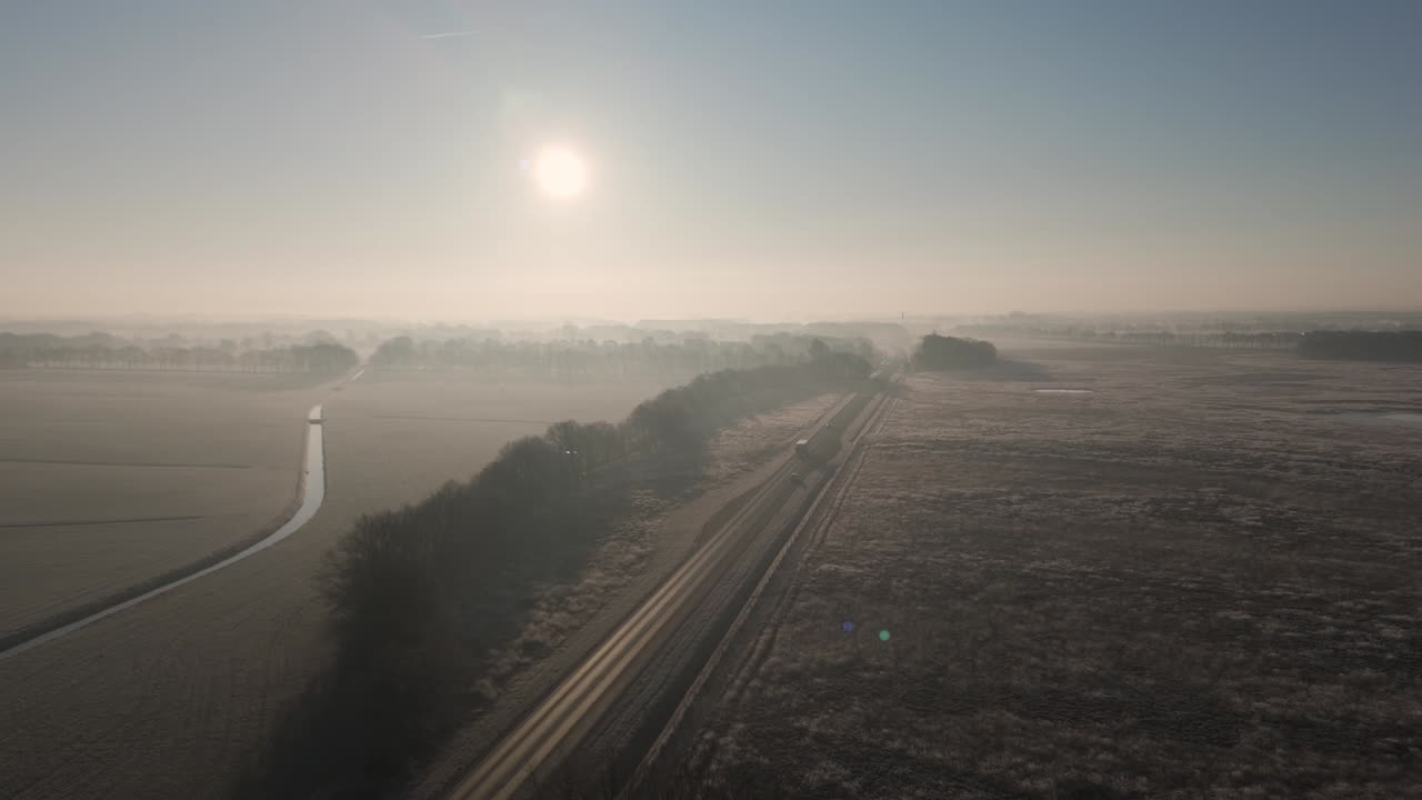 Winter Sunrise Over a Foggy Country Road
