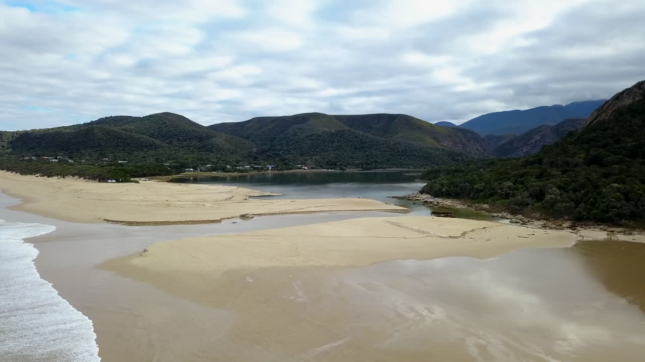 An aerial shot flying over the lagoon with reflections at Nature's Valley in the Garden Route of South Africa