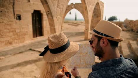 tourists looking at map on summer holidays in the mediterranean