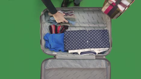 packing a suitcase on green screen