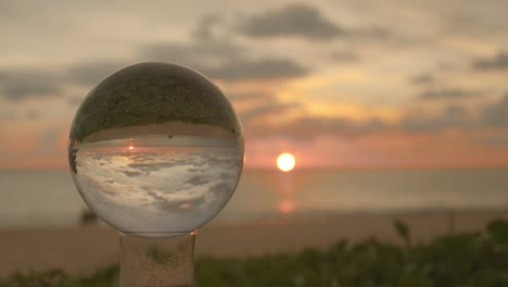 beautiful sunrise above the sea inside crystal ball.