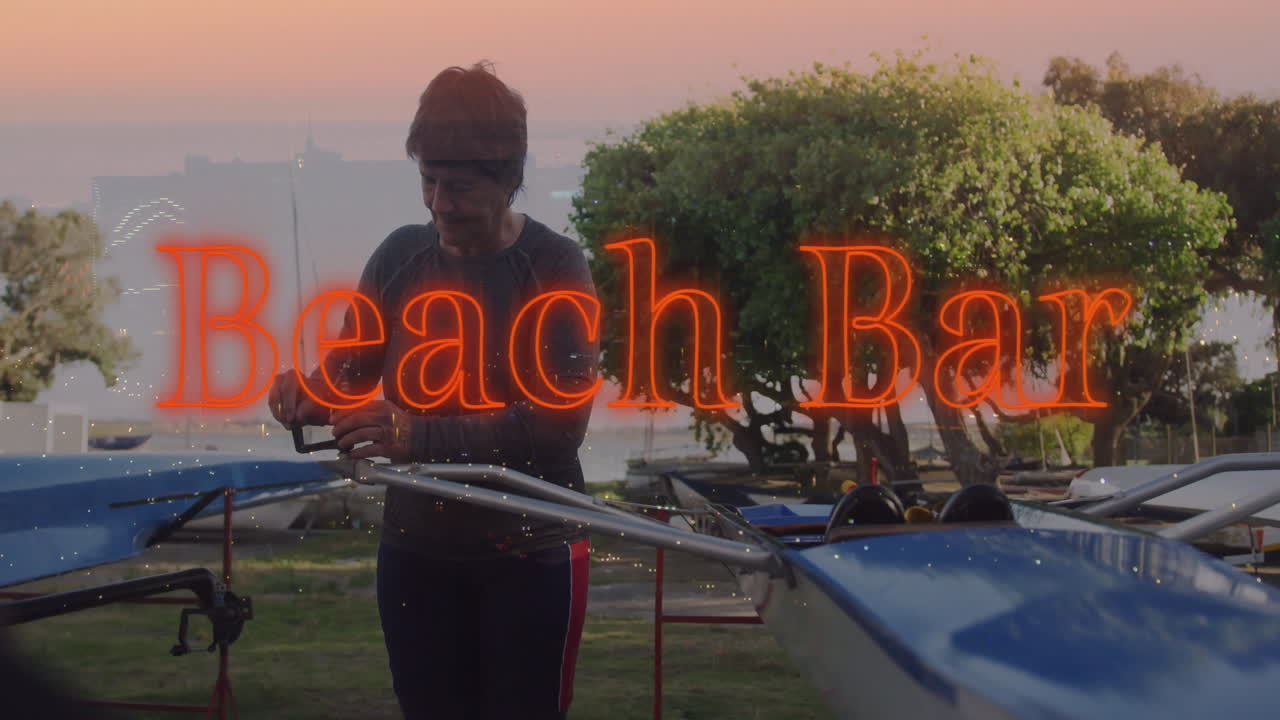 Senior female rower adjusting boat rigging in health training at sunset with neon Beach Bar overlay