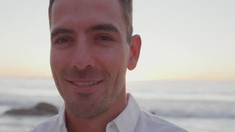 portrait of young man smiling at the seaside