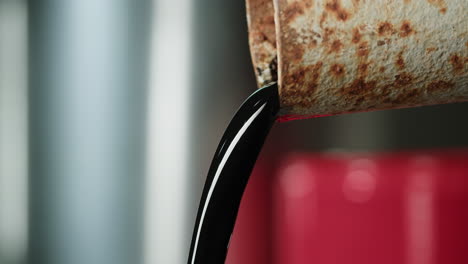 oil pouring from a rusty pipe