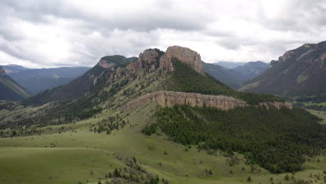 scenic mountain landscape with green hills and rock formations under cloudy skies