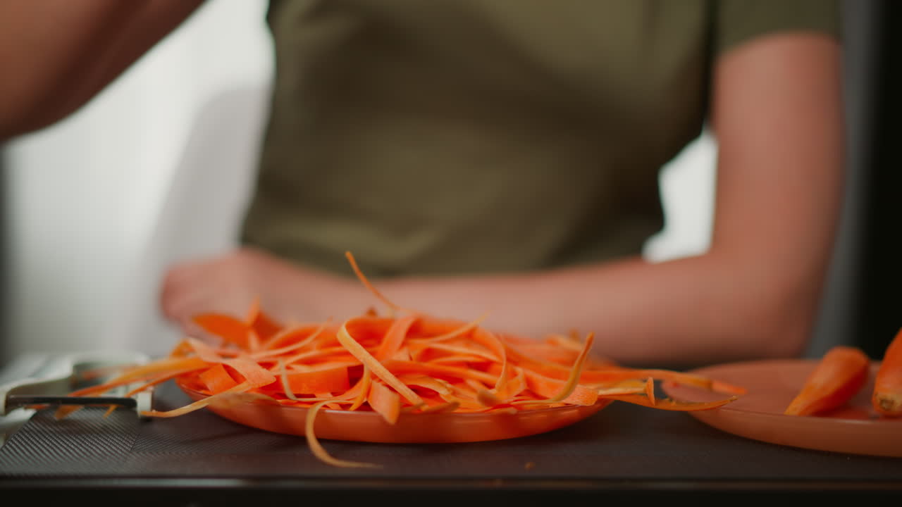 Woman Shredding Carrots
