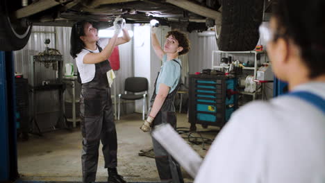 women working on a vehicle