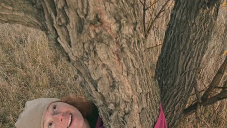 woman embracing a tree in autumn woods