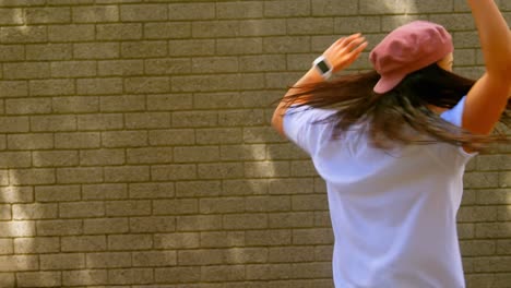 beautiful young dancer dancing against the brick wall in the city 4k