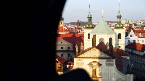 pictorial cityscape with spires over red roof buildings