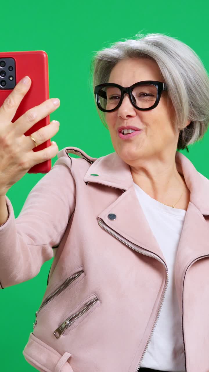 Happy Senior Woman Talking and Gesturing on a Video Call
