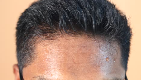 man's forehead with sweat