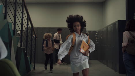 School-girl-running-downstairs-on-break.-African-american-child-sitting-bench.