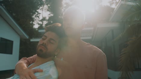 two men hugging outdoors