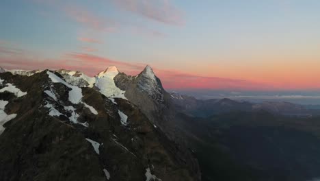 Drone-shot-of-a-quiet-and-colorful-morning-over-the-alpine-mountains-in-Switzerland