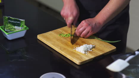 chef chopping onions and herbs