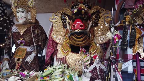 barong displayed, mystical creature balinese hinduism temple religious ceremony with colorful flower offerings