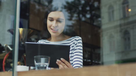 portrait of a smiling woman in a cafe