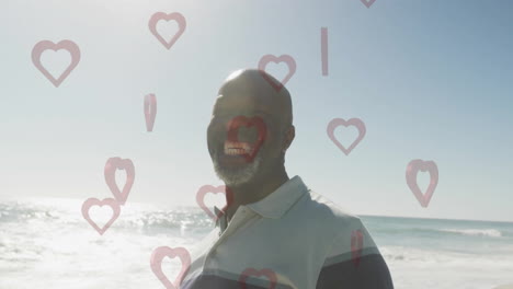 animation of heart shapes floating around man smiling at beach