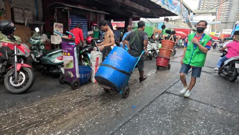 people carrying goods through a busy market