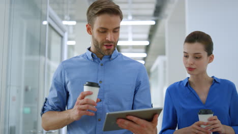 Creative-people-using-tablet-during-coffee-break.-Colleagues-going-on-office.