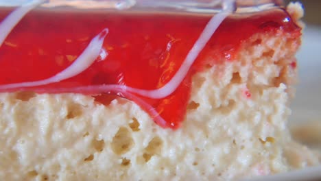 close-up of a dessert with red glaze and white icing