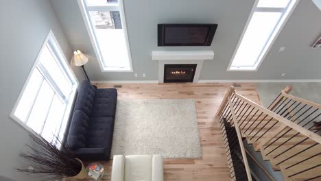 modern living room with tall ceiling shown from above 2nd floor real estate