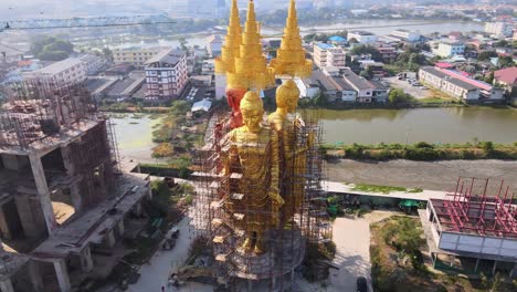 4k aerial huge statue of three buddhist sculptures in the ancient siam city in samut prakan province, bangkok, thailand