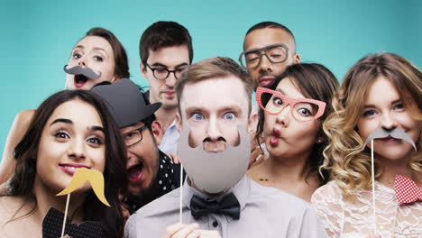 multi racial group of funny people celebrating slow motion party photo booth