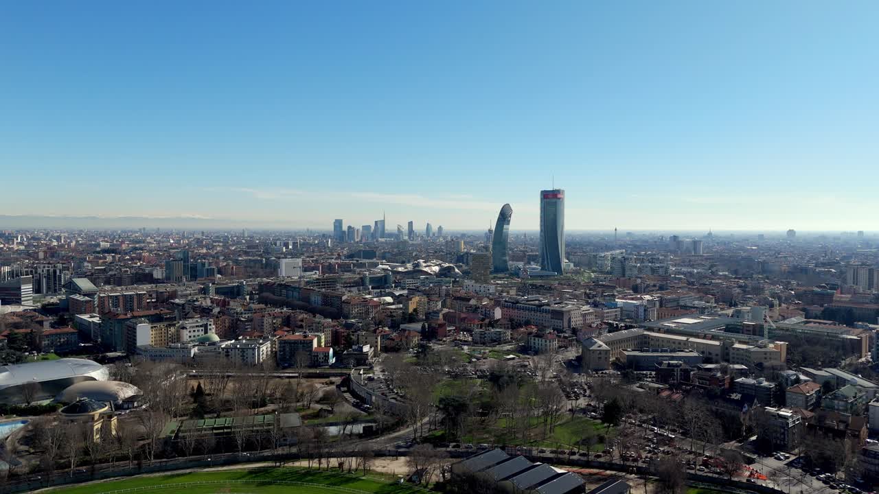 Milan skyline with the leaning tower in the distance, showing city skyscrapers, architecture, and urban landscape