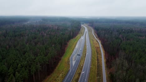 traffic on a two-lane road. high-altitude drone shot on a gloomy autumn day