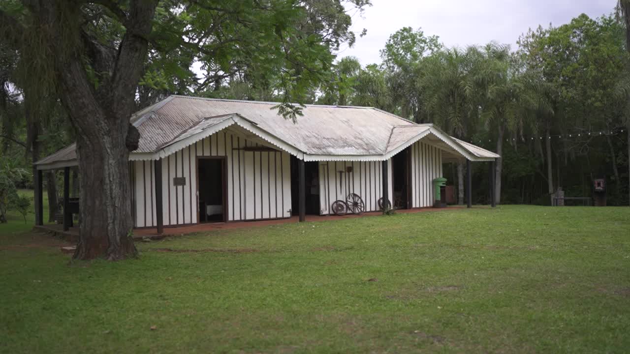 Historic wooden house surrounded by green forest in Misiones Argentina, literary heritage and cultural tourism