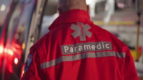 Back,-man-and-paramedic-walking-to-ambulance