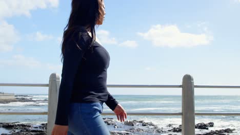 Side-view-of-disabled-woman-walking-on-promenade-near-railing-4k