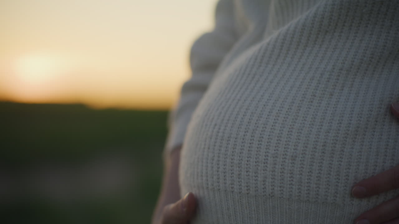 Pregnant Woman in Sunset Silhouette