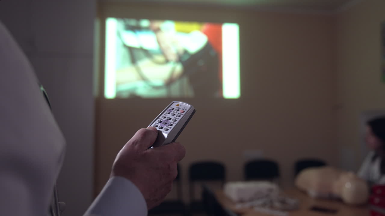 Medic in training center. Mannequin and medical equipment on a table. Instructor preparing to explaining the reanimation procedure near the doll model