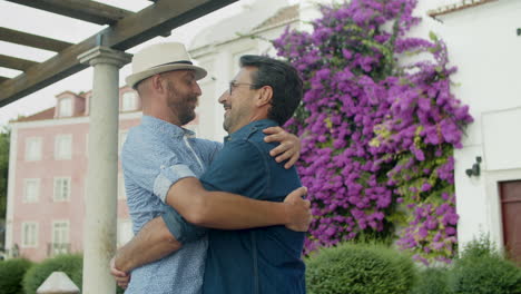 Slow-motion-of-happy-gay-couple-hugging-and-kissing-on-blooming-park