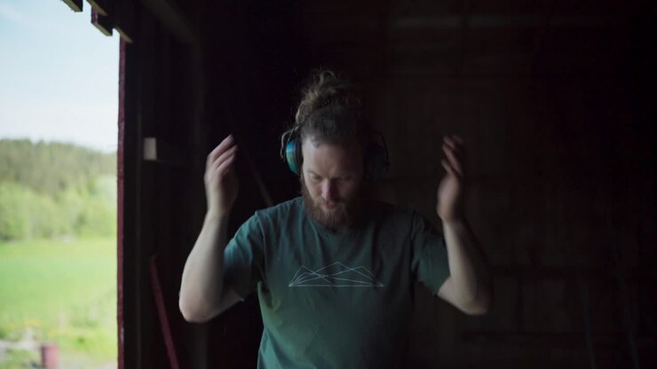 Man Blows And Shakes Off Dust From Arms, Head, And Body