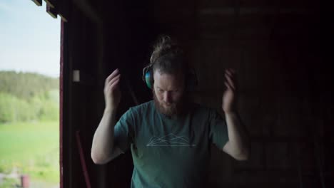 man blows and shakes off dust from arms, head, and body