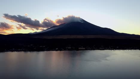 dawn breaks over mount fuji with serene lake reflections and a tranquil sky