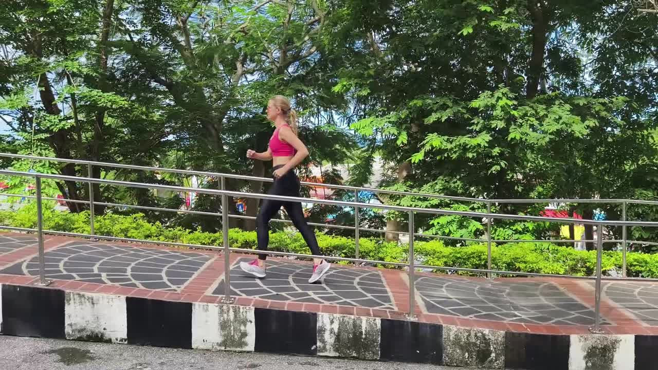 mujer corriendo por un camino del parque