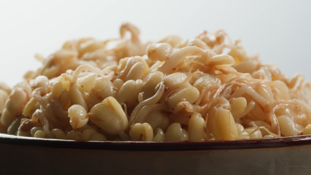 Salted soybean fermented in jar, chinese soy production, marinated food, germinated soy close up in cafe restaurant.