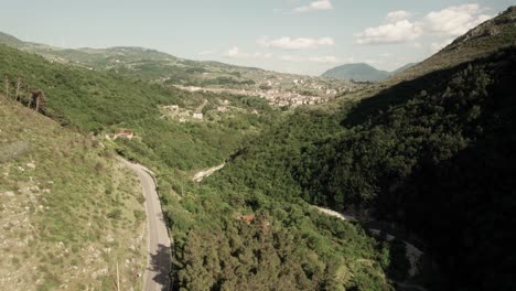 aerial forward view of fantastic valley in mountains with houses. italy
