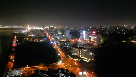 a vibrant nighttime urban cityscape in maputo, mozambique - aerial drone shot