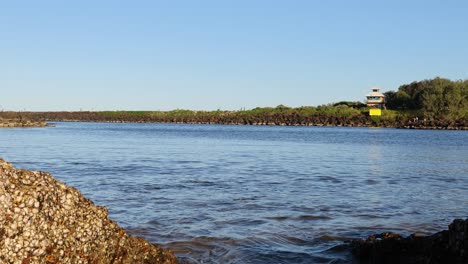 waves gently lap against rocky shore